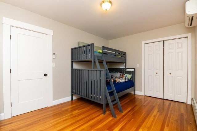 15 Dundee Rd, Quincy, MA 02171 - bedroom with light wood-style flooring, a wall mounted AC, and baseboards