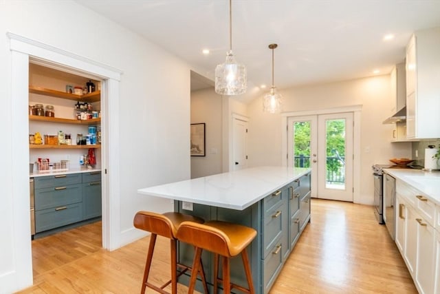 15 Dundee Rd, Quincy, MA 02171 - kitchen featuring a center island, light wood-style flooring, blue cabinets, pendant lighting, and recessed lighting