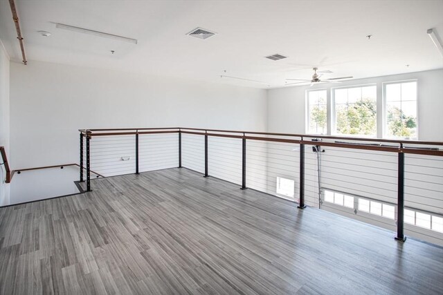 unfurnished room with ceiling fan and hardwood / wood-style flooring