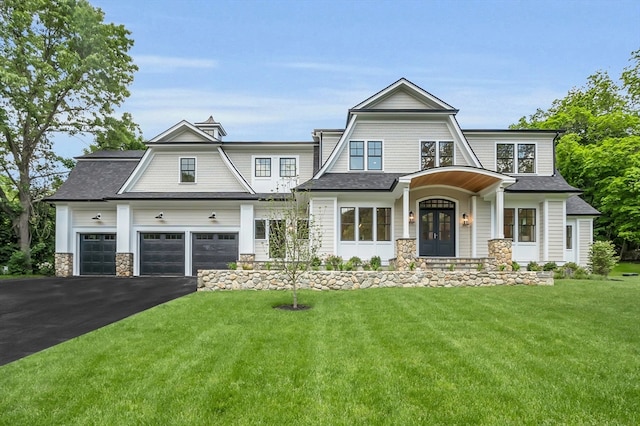 craftsman inspired home featuring a garage and a front yard