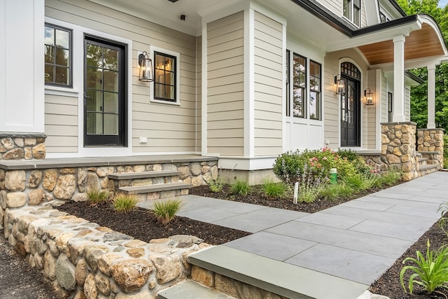 view of exterior entry featuring a porch