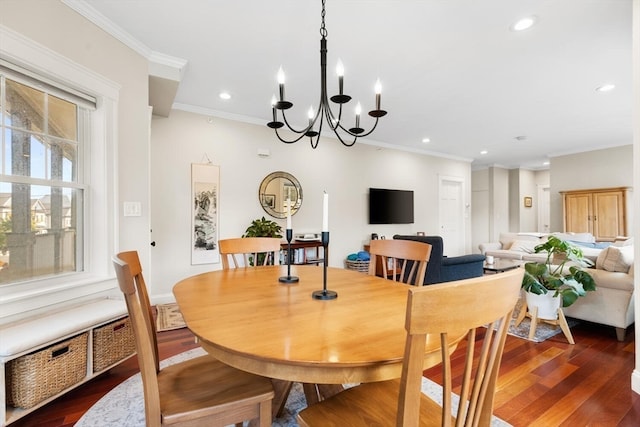 dining room featuring ornamental molding, dark wood-type flooring, and a chandelier