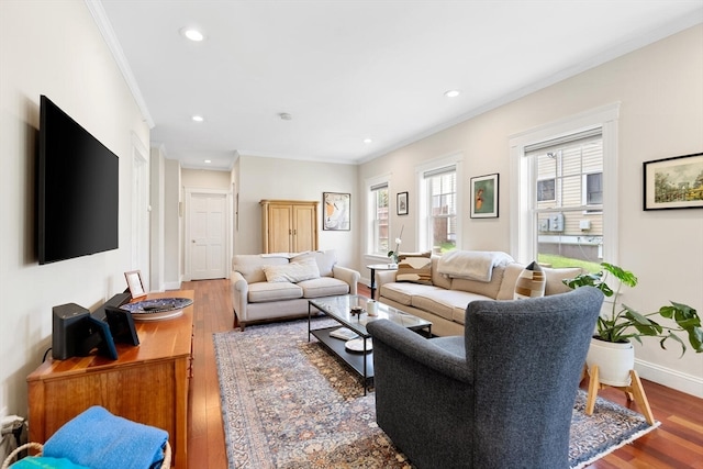 living room with crown molding and hardwood / wood-style flooring