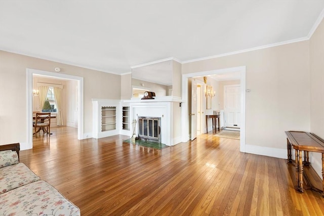 living room with ornamental molding, hardwood / wood-style flooring, and a notable chandelier