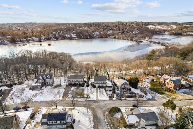 snowy aerial view featuring a water view