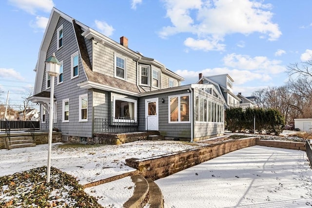 view of front of home with a sunroom