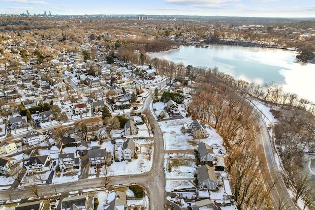 snowy aerial view featuring a water view