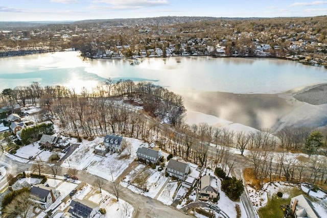 snowy aerial view featuring a water view