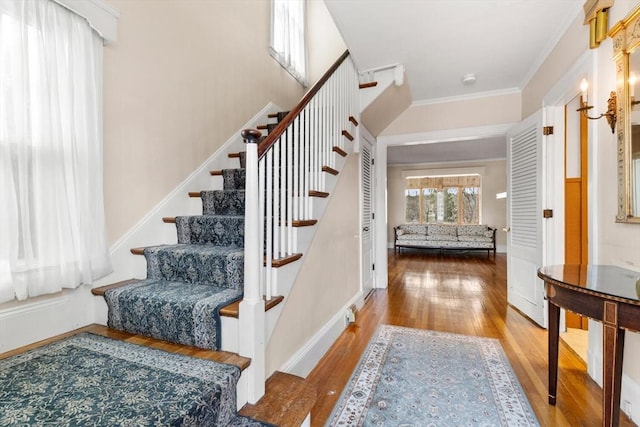 stairway featuring wood-type flooring and ornamental molding