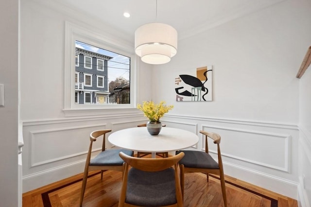 dining area with a wainscoted wall, a decorative wall, and recessed lighting