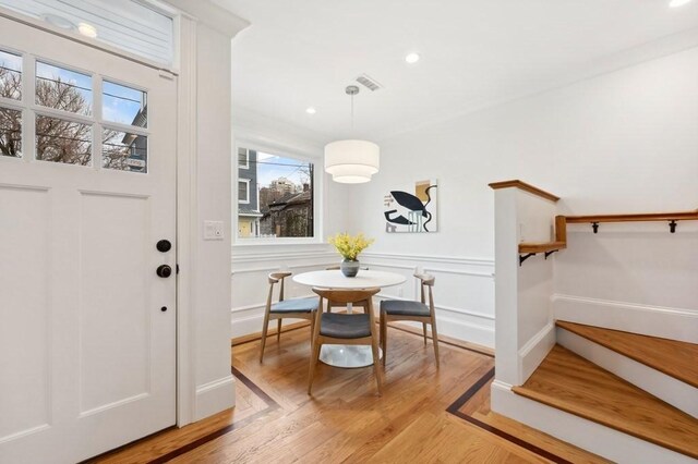 entryway featuring a decorative wall, recessed lighting, light wood-style flooring, and baseboards