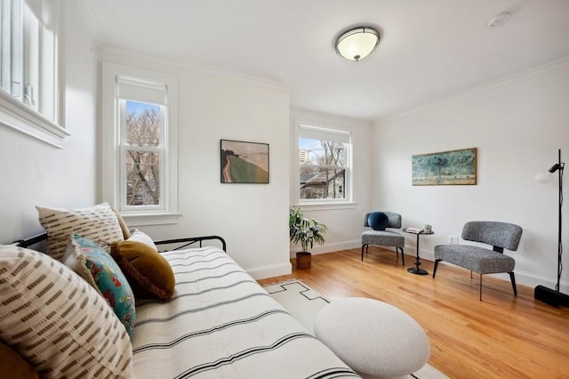 interior space with ornamental molding, baseboards, and wood finished floors