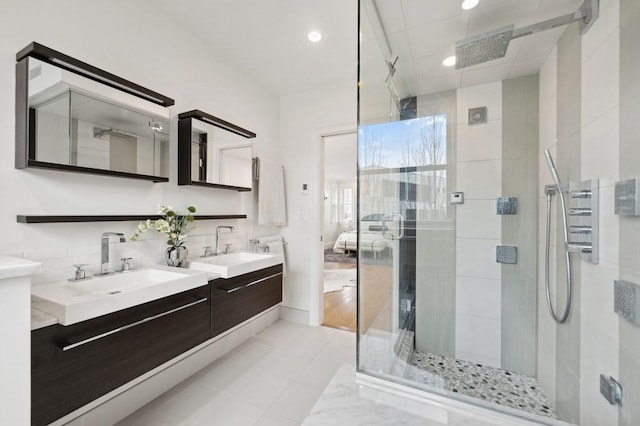 full bath featuring double vanity, a sink, visible vents, and a shower stall