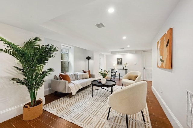 living area with recessed lighting, visible vents, baseboards, and wood finished floors