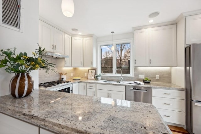 kitchen featuring visible vents, white cabinets, stainless steel appliances, under cabinet range hood, and a sink