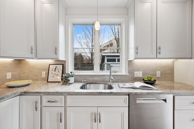 kitchen featuring tasteful backsplash, a sink, white cabinetry, and pendant lighting