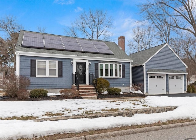 view of front of property with solar panels, a chimney, and roof with shingles