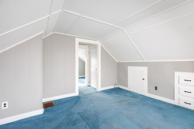 additional living space featuring baseboards, visible vents, lofted ceiling, and carpet floors