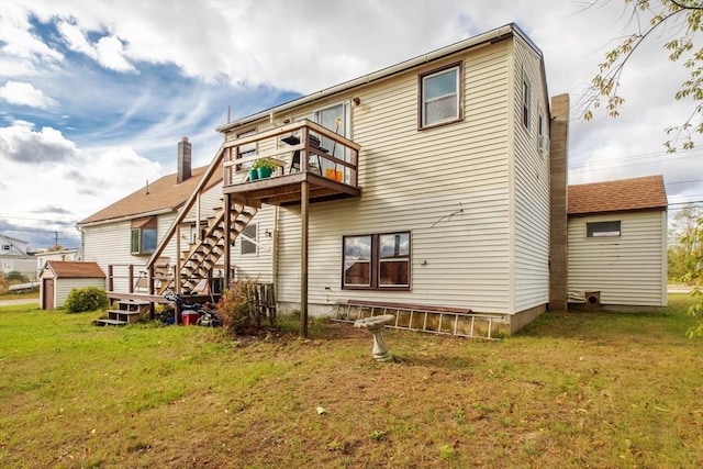 rear view of property with a lawn, a wooden deck, and stairs