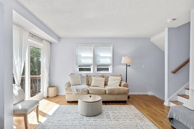 14 Russell Dr Unit 4D, Salem, MA 01970 - living area with a textured ceiling, stairway, wood finished floors, and baseboards