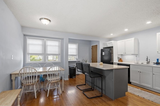 14 Russell Dr Unit 4D, Salem, MA 01970 - kitchen featuring freestanding refrigerator, a sink, plenty of natural light, a center island, and a textured ceiling