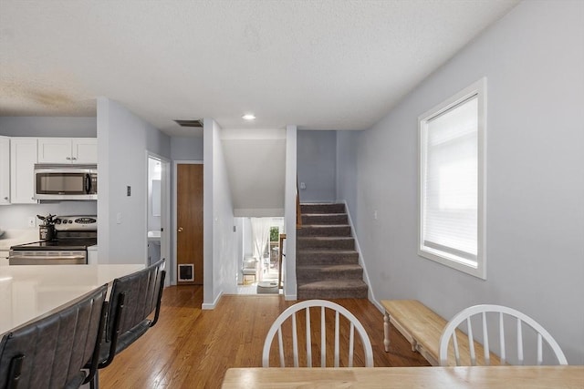 14 Russell Dr Unit 4D, Salem, MA 01970 - kitchen with appliances with stainless steel finishes, white cabinets, light wood finished floors, light countertops, and baseboards