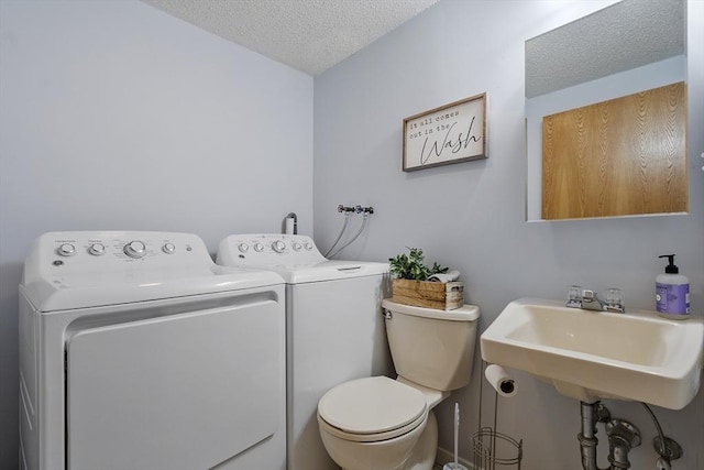 14 Russell Dr Unit 4D, Salem, MA 01970 - bathroom with washer and clothes dryer, a textured ceiling, toilet, and a sink