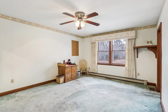 spare room featuring ceiling fan, carpet, and a baseboard heating unit