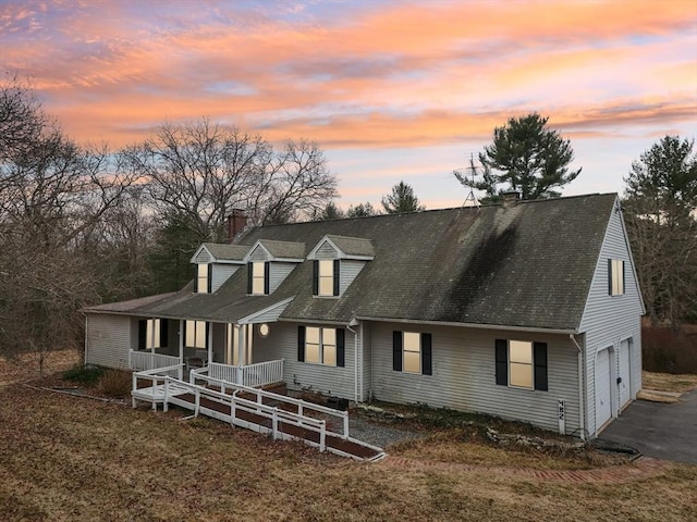 cape cod house featuring a porch