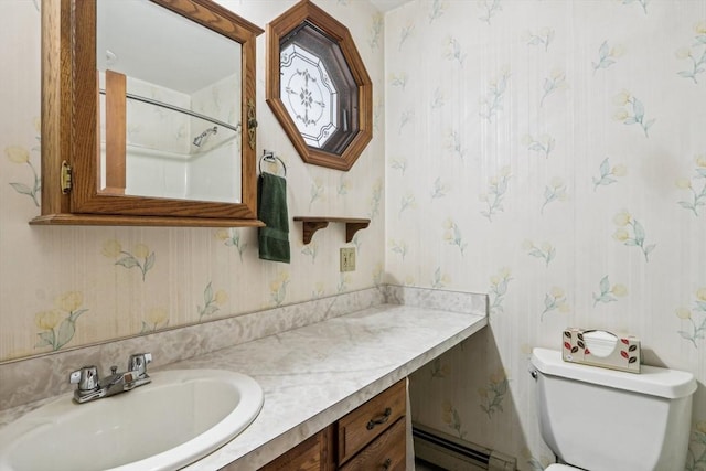 bathroom with toilet, vanity, and a baseboard heating unit