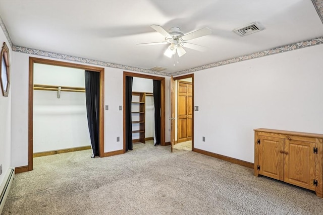 unfurnished bedroom with multiple closets, ceiling fan, light colored carpet, and a baseboard radiator