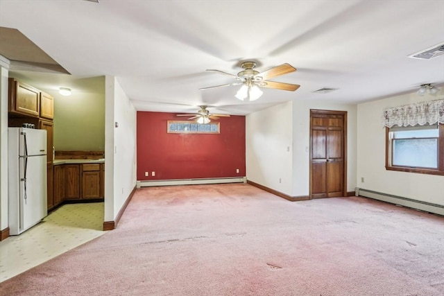 unfurnished living room with baseboard heating, ceiling fan, and light colored carpet