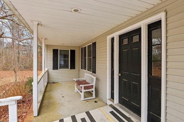 view of exterior entry featuring a porch