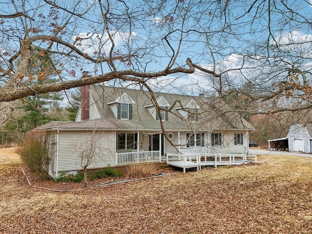 rear view of house featuring covered porch