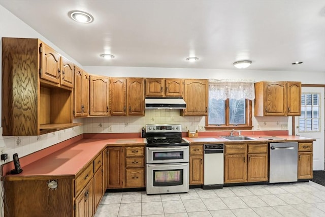 kitchen with backsplash, light tile patterned flooring, sink, and appliances with stainless steel finishes