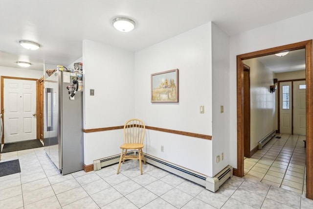 hall featuring light tile patterned floors and a baseboard heating unit