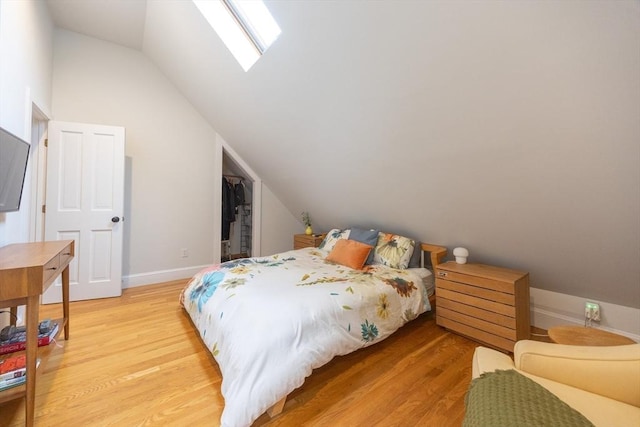 34 Lewis Ave Unit 34, Arlington, MA 02474 - bedroom featuring lofted ceiling, light wood-style flooring, a skylight, a walk in closet, and a closet