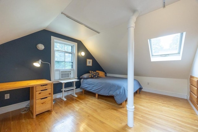 34 Lewis Ave Unit 34, Arlington, MA 02474 - bedroom with cooling unit, a skylight, light wood-style flooring, and vaulted ceiling