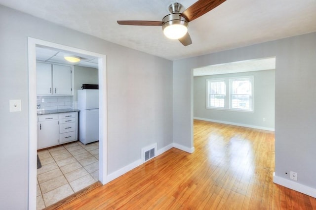 unfurnished room featuring ceiling fan and light wood-type flooring