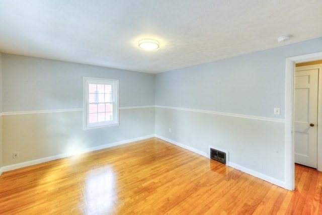 unfurnished room with hardwood / wood-style floors