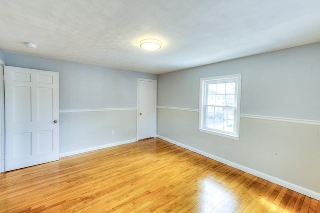 unfurnished room with wood-type flooring