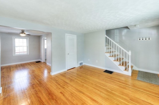 interior space with hardwood / wood-style flooring, ceiling fan, and a textured ceiling