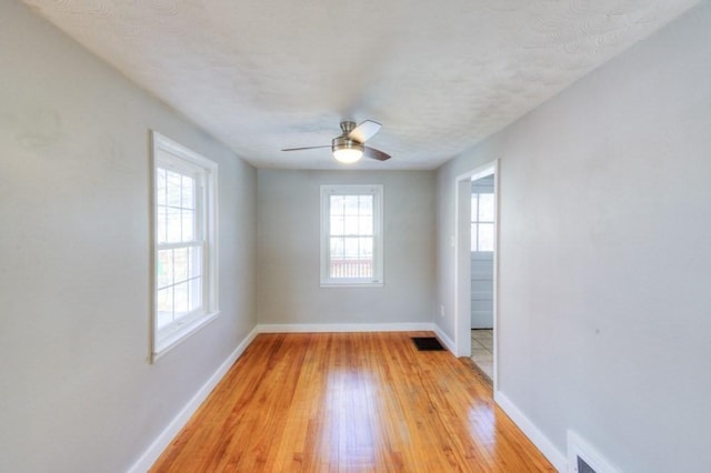 unfurnished room with ceiling fan and light hardwood / wood-style floors