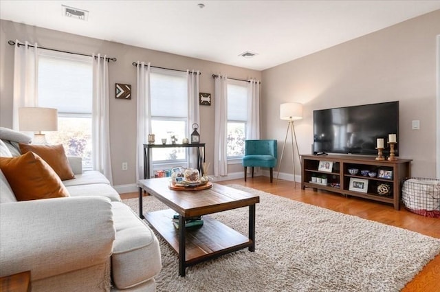 living area featuring wood finished floors and baseboards