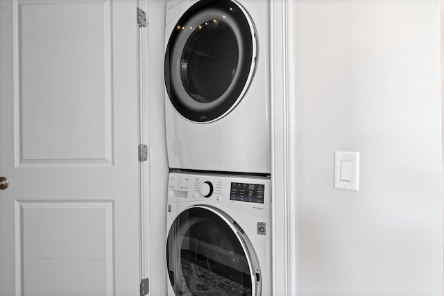 laundry area with stacked washer / dryer
