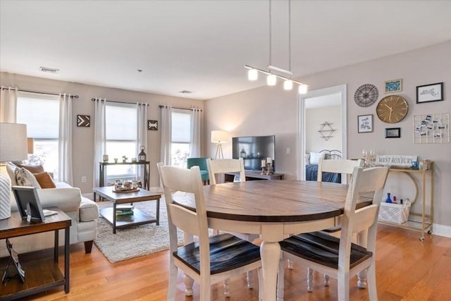 dining room with light wood-style floors and baseboards