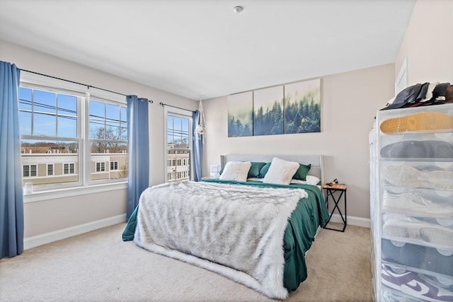 carpeted bedroom with baseboards