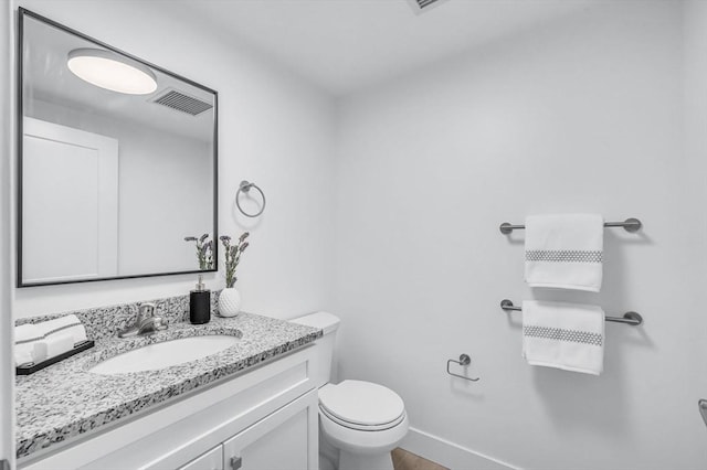 45 Morris St Unit 106, Springfield, MA 01105 - half bathroom featuring vanity, toilet, and baseboards
