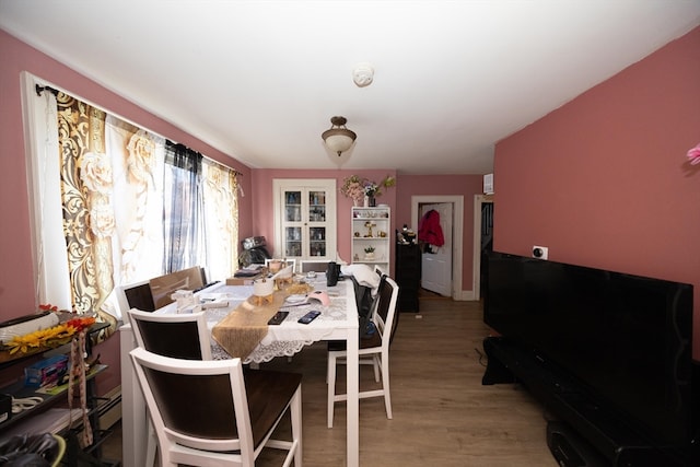 dining area with baseboard heating and light wood-type flooring