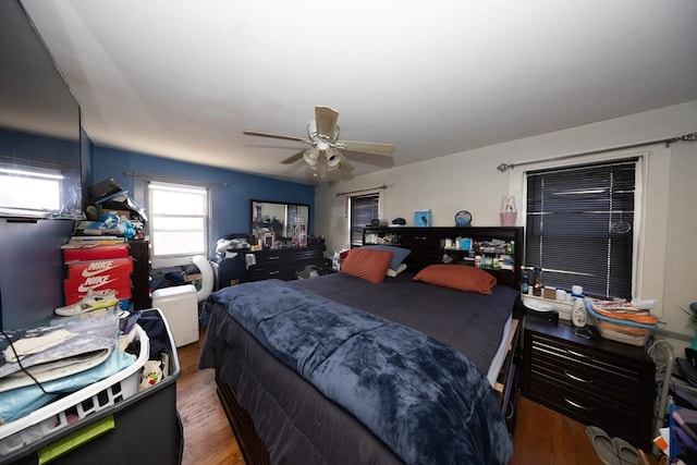 bedroom with dark wood-type flooring and ceiling fan